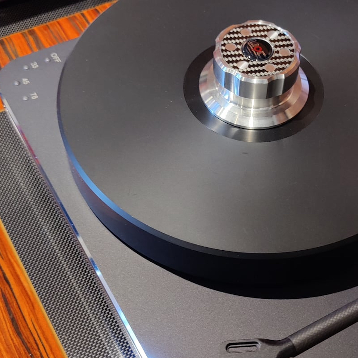 Ultra Carbon TC40 Record Clam displayed on a Turntable to show how the TC40 works